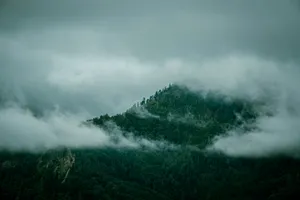 A mountain covered in fog and low lying clouds jigsaw puzzle
