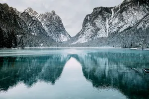 body of water and snow-covered mountains during daytime jigsaw puzzle