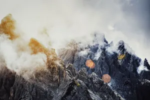 Explore dramatic rocky mountain peaks shrouded in clouds, creating a mystical landscape. jigsaw puzzle