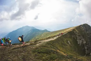 A group of hikers traverses a foggy mountain ridge, capturing the serene beauty of nature. jigsaw puzzle