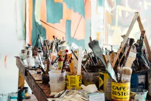 assorted-color paint brush on brown wooden table top jigsaw puzzle