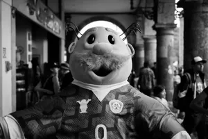Smiling mascot character entertaining at a lively outdoor event. jigsaw puzzle