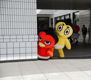 Vibrant mascot characters playfully peeking around a corner in a modern urban environment. jigsaw puzzle