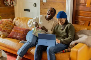 a person sitting on a couch with a laptop jigsaw puzzle