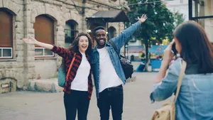 Two cheerful travelers posing for a photo in a city street, capturing joyful memories. jigsaw puzzle