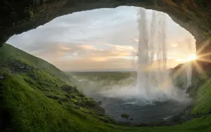 waterfalls near cave at daytime jigsaw puzzle