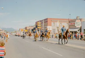 A group of people riding horses down a street jigsaw puzzle