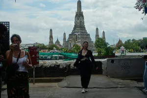 Two women walk with a temple in the background. jigsaw puzzle