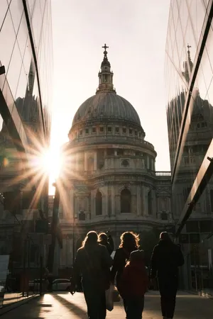 Dramatic sunset view of St Paul's Cathedral, London, with silhouettes of people and modern reflections. jigsaw puzzle