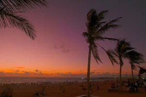 crimson sky over people in beach at sunset jigsaw puzzle