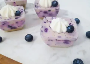 four square pastries with icing and blueberry on top jigsaw puzzle