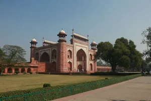 A red and white building sitting on top of a lush green field jigsaw puzzle