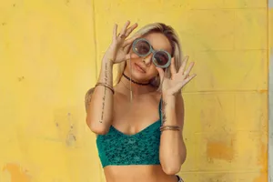 woman in blue bralette holding sunglasses putting on her eyes jigsaw puzzle