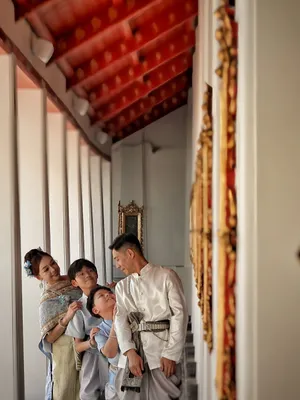 An Asian family in traditional attire enjoying a day at a Bangkok temple, exuding cultural charm. jigsaw puzzle