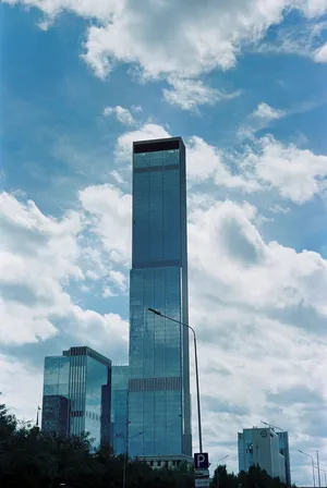 Tall modern skyscrapers against a bright blue sky, capturing Astana's urban architecture. jigsaw puzzle
