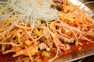 Close-up of a vibrant Korean seafood and noodle dish with kimchi. jigsaw puzzle