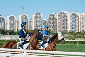 Jockeys on racehorses at a racetrack with a city skyline, combining sport and architecture. jigsaw puzzle