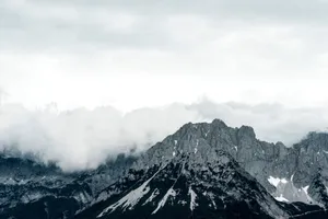 Grayscale view of Wilder Kaiser mountains with dramatic clouds casting shadows, Austria. jigsaw puzzle