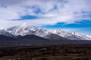 Majestic snow-capped mountains stretch under a vibrant blue sky, showcasing natural beauty. jigsaw puzzle
