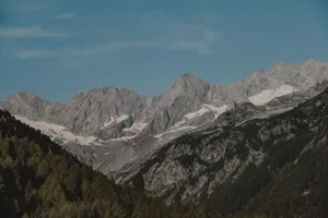 Breathtaking view of alpine mountains with snow under a clear blue sky. jigsaw puzzle