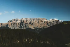 Breathtaking landscape photo of the Sella Group mountains in the Dolomites under a clear blue sky. jigsaw puzzle