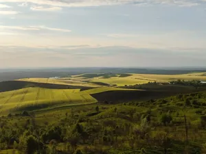 Breathtaking view of rolling hills and fields under a dramatic sunset sky near Chernovtsy, Ukraine. jigsaw puzzle
