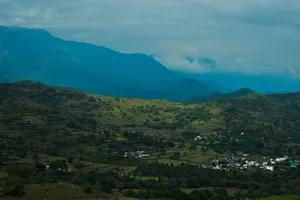 A breathtaking aerial view of a verdant valley and village amidst rolling hills in Kerala, India. jigsaw puzzle