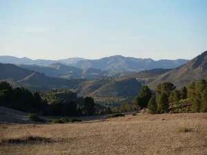 Beautiful mountain landscape with rolling hills under a clear sky, perfect for nature lovers. jigsaw puzzle