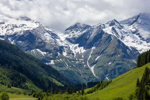 Breathtaking view of snow-capped mountains and lush greenery in the Alps. jigsaw puzzle