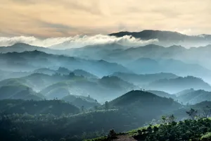 Capture of breathtaking misty mountain ranges under sunrise glow. jigsaw puzzle