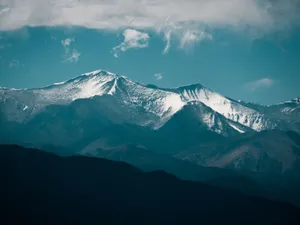 Majestic snow-capped mountains under a clear blue sky capture the beauty of nature. jigsaw puzzle