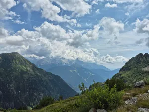 Breathtaking view of the Dolomites in Italy with lush green valleys and dramatic clouds. jigsaw puzzle