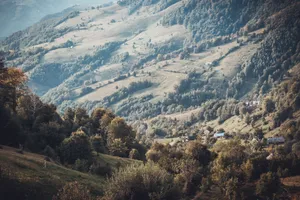 Beautiful mountain landscape with rolling hills and scattered houses in daylight. jigsaw puzzle
