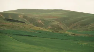 A serene landscape with rolling green hills under an overcast sky, perfect for nature lovers. jigsaw puzzle