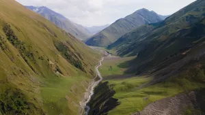 A breathtaking aerial view of the lush green valleys and majestic mountains in Dagestan, Russia. jigsaw puzzle
