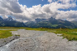 Scenic view of Alpine mountains with green valleys and cloudy sky, ideal for travel themes. jigsaw puzzle