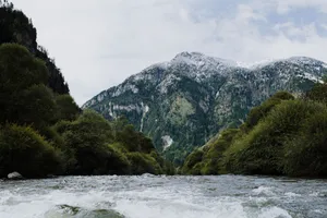 Stunning view of a mountain with a river in a lush green valley. jigsaw puzzle