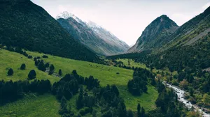 A stunning aerial view of green valleys and towering mountains in Chunkurchak, Kyrgyzstan. jigsaw puzzle