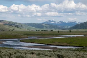 Stunning landscape of Yellowstone with mountains and river flow during the day. jigsaw puzzle