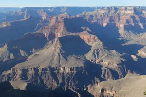 A stunning aerial view of the Grand Canyon showcasing its majestic cliffs, layers, and sunlight. jigsaw puzzle