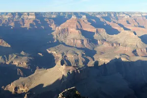 Capture of the Grand Canyon's vast and intricate rock formations at sunrise, showcasing geological beauty. jigsaw puzzle