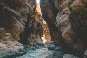 Stunning view of a mountain gorge with a flowing river and towering rocky cliffs. jigsaw puzzle