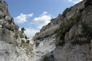 Explore the rugged beauty of a rocky canyon under a bright blue sky. Perfect for outdoor adventures. jigsaw puzzle