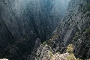Explore the breathtaking views of a massive rocky canyon with steep cliffs, perfect for adventure seekers. jigsaw puzzle
