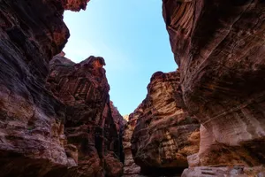 Experience the beauty of a sandstone canyon glowing under the sunrise, highlighting the intricate geological formations. jigsaw puzzle