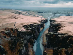 A dramatic aerial view showcasing a rugged canyon with a winding river. Perfect for nature enthusiasts. jigsaw puzzle