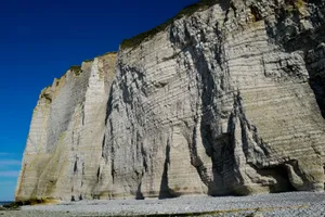 Stunning limestone cliffs with rugged texture against clear blue sky, showcasing natural beauty and rocky formations. jigsaw puzzle