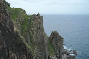 Majestic rocky cliff overlooking the ocean, showcasing natural beauty and geological formations. jigsaw puzzle