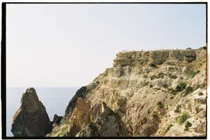 A breathtaking view of the dramatic cliffs at Cape Fiolent, showcasing the rugged coastal beauty and expansive ocean backdrop. jigsaw puzzle