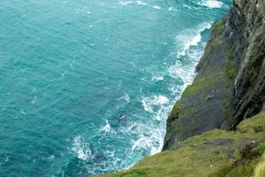 Stunning view of Irish cliffs and ocean waves crashing at the base. jigsaw puzzle